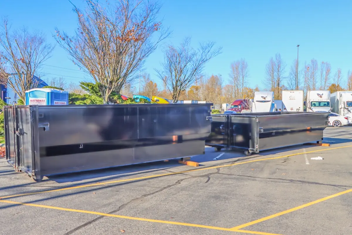 Professional dumpster rental service with roll-off container on residential driveway in La Crosse